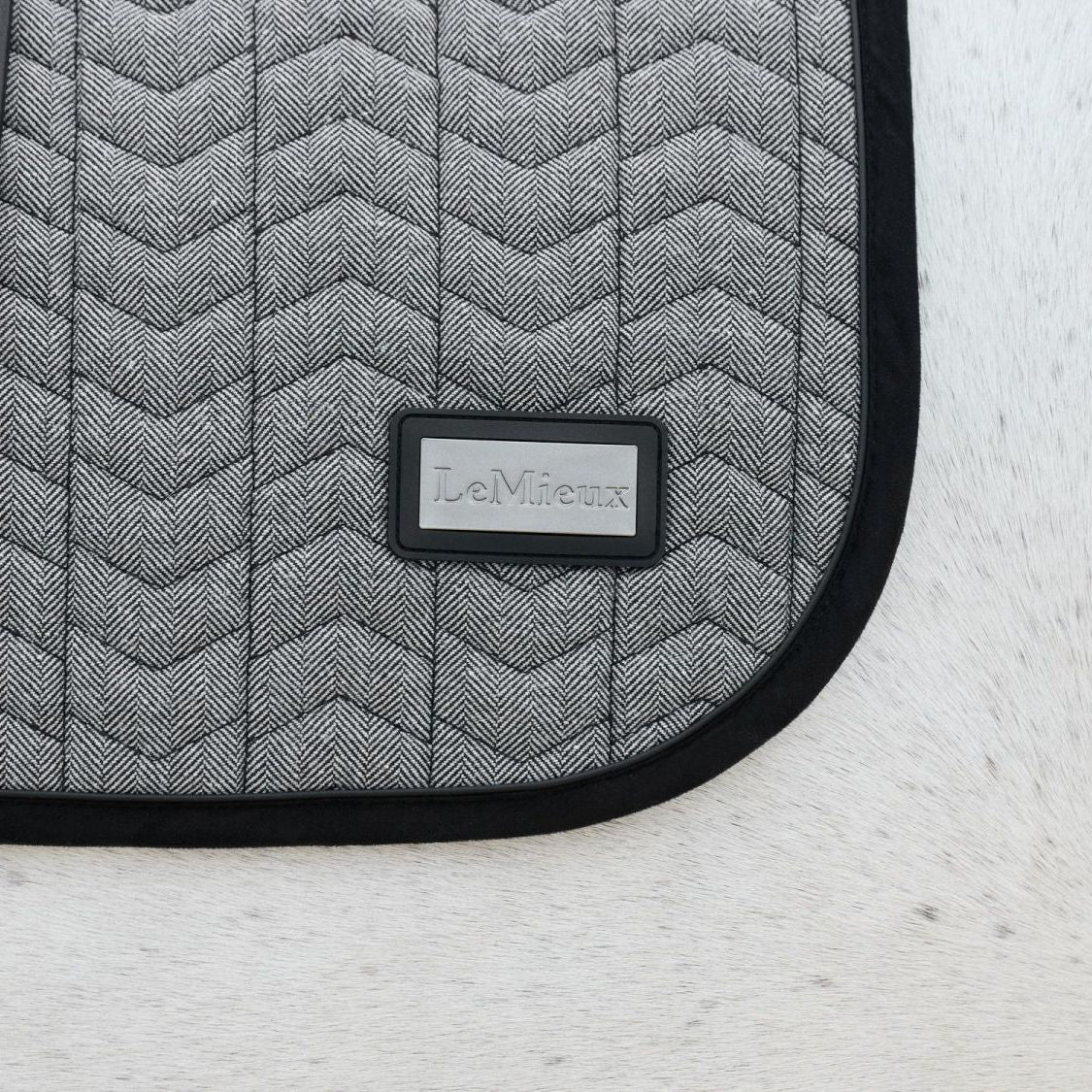Detail LeMieux Schabracke Aspen Dressage Square Herringbone schwarz weiß, Fischgrätmuster, mit Chevron-Steppung, schwarze Lackpaspel, robuste Velours-Einfassung, hochwertiges Material.