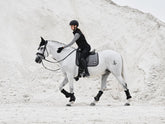 Reiterin und Pferd im eleganten Partnerlook mit LeMieux Aspen Dressage Square Herringbone schwarz weiß Schabracke, modische Capsule Collection, stilvolle Dressurausrüstung.
