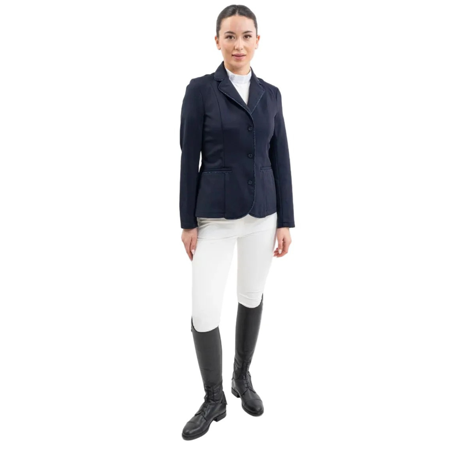 Eine Turnierreiterin präsentiert ein komplettes Harcour Turnieroutfit. Sie trägt das Damen Turnierjacket Oria in Navy, kombiniert mit weißer Turnierreithose und dem Harcour Turniershirt Shine mit weißem Latz. Dieses edle Reitsakko setzt optische Highlights und bietet maximale Sicherheit: Es ist kompatibel mit dem Harcour Ouraye HIT AIR Airbag und allen Airbagwesten, die unter der Turnierkleidung getragen werden. Ein elegantes und sicheres Reitoutfit für den anspruchsvollen Turniersport.