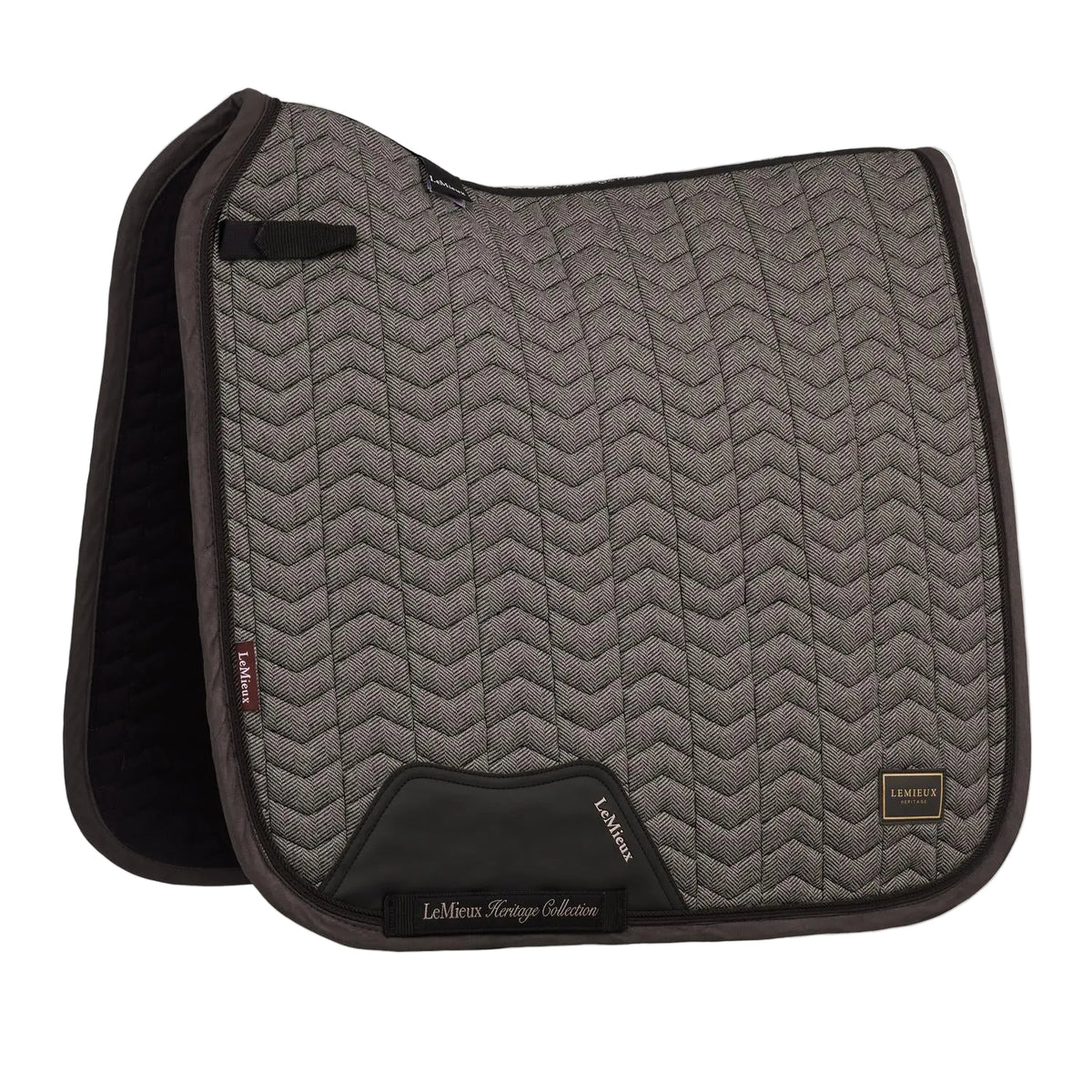 Die braune LeMieux Heritage Dressurschabracke Herringbone Dressage Square in Cocoa zeigt ihr edles Fischgrätmuster in Chevron-Steppung, den anatomischen Schwanenhals-Schnitt für Widerristfreiheit und den verstärkten PU-Leder-Gurtschutz sowie die D-Ring-Befestigung.