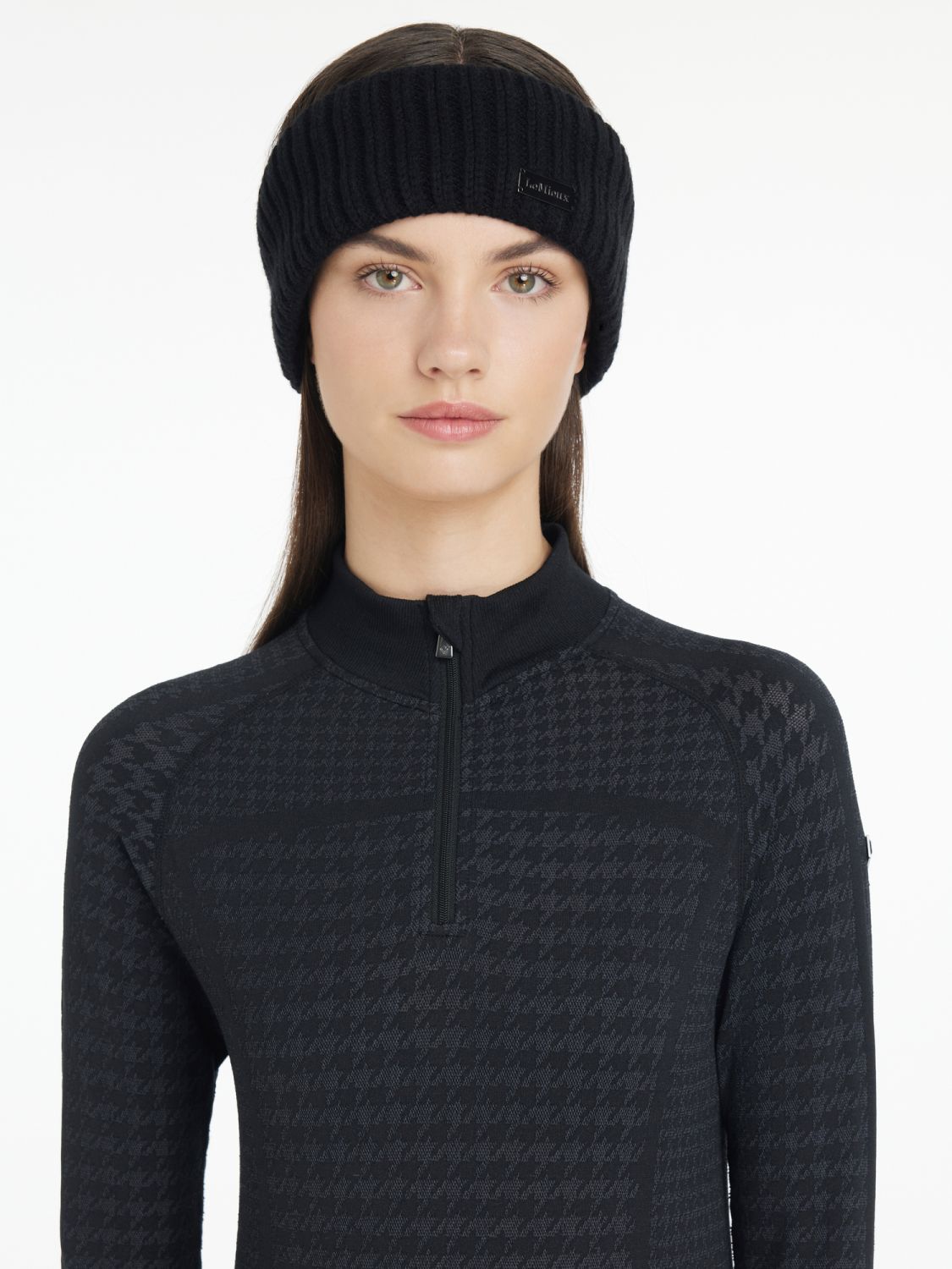 Reiterin trägt LeMieux Stirnband Aspen Schwarz von vorne – elegantes, fleecegefüttertes Stirnband für kalte Tage im Stall. Kombiniert mit den Aspen Quarter Zip Top Houndstooth mit Hahnentrittmuster. Eine gelungene Kombination aus der Aspen Kollektion von LeMieux.