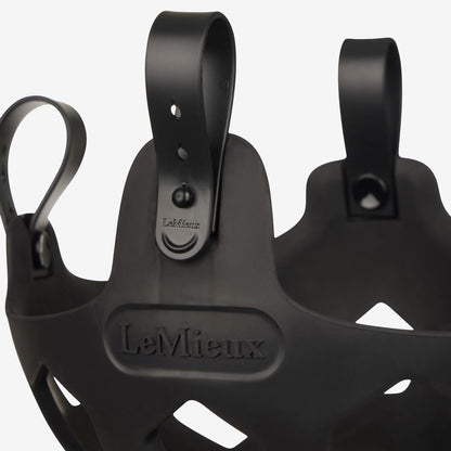 Hochauflösendes Produktdetail des schwarzen LeMieux Weidemaulkorbs Noma. Gezeigt wird die geschlossene Schlaufe mit Pin im ausgewählten Loch. Zum schnellen Öffnen und einfachen Abnehmen der Fressbremse direkt am Pferd wird die Schlaufe unkompliziert vom Pin weggezogen.