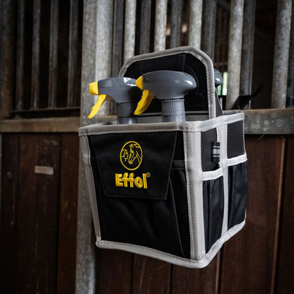 Die handliche Mini-Tote-Bag-Putztasche von Effol kann mit Hilfe von Schlaufen an der Boxentür aufgehängt werden. Hier sieht man, dass die kleine Putztasche mit 4 Fächern an der Boxentür hängt und alle Pferdepflegeutensilien (die wichtigsten) sofort griffbereit sind. Kein Bücken nötig. Diese praktische und effiziente Lösung vereinfacht die Pferdepflege im Alltag.