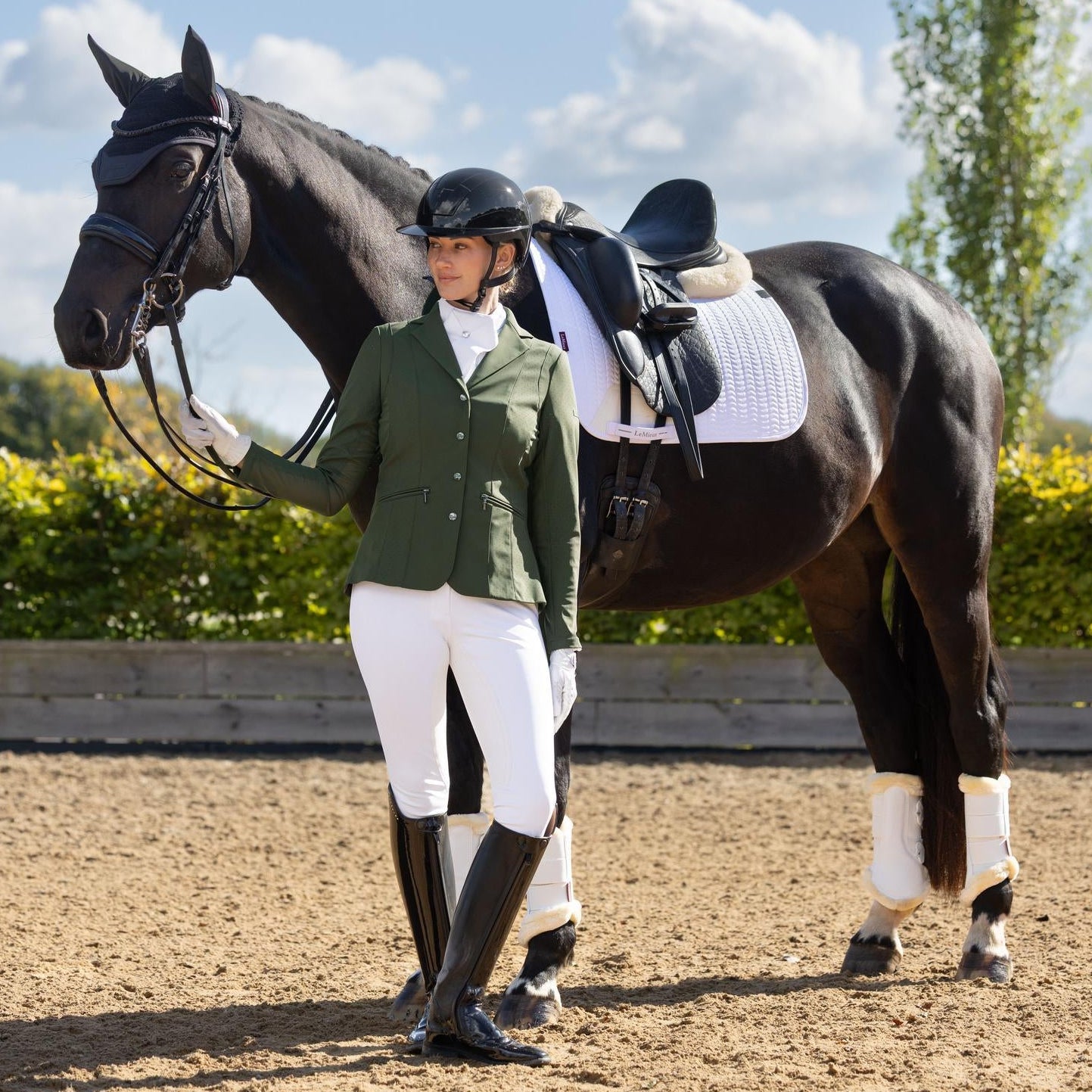 Hochtechnische Performance im Dressurviereck: Die weiße LeMieux Essence Turnierschabracke kombiniert eine klassische Turnier-Optik mit extrem schweißabsorbierenden Effekten. Während die Außenseite traditionelle Eleganz ausstrahlt, sorgt das kühlende Self-Cool-Gewebe bei sommerlichen Turniertemperaturen für eine aktive Temperaturregulierung. Diese Verbindung aus technischem High-Tech-Stoff und zeitlosem Design garantiert ein trockenes Gefühl unter dem Sattel.