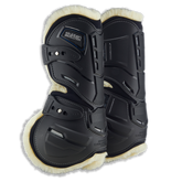 Paar Stübben Hybrid Springgamaschen der Evolution Serie in Schwarz für die Vorderbeine mit kontrastierendem hellem Fleece-Futter. Das Bild zeigt das innovative seitliche Cut-Out-System, das natürliche Bewegungsabläufe wie Stauchen und Dehnen am Pferdebein ermöglicht. Sichtbar sind die strategischen Belüftungsöffnungen gegen Hitzestau sowie die elastischen Schnellverschlüsse. Das beigefarbene Fleece-Fell für empfindliche Pferde bildet einen eleganten Kontrast zur schwarzen Hartschale.
